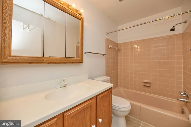 full bathroom featuring tiled shower / bath combo, toilet, tile patterned floors, and vanity