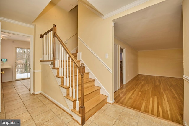 stairway featuring tile patterned floors and ornamental molding