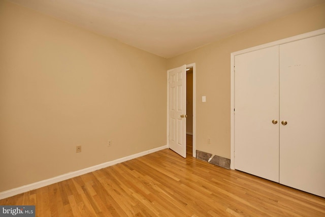 unfurnished bedroom with light wood-type flooring