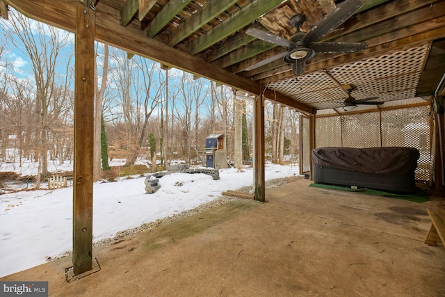 snow covered patio featuring ceiling fan