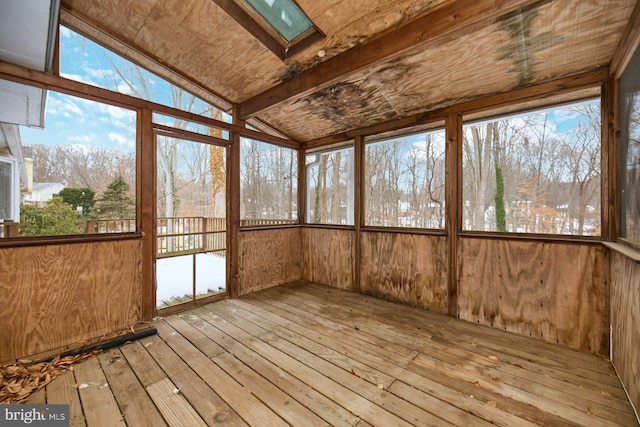 unfurnished sunroom with lofted ceiling with skylight and a healthy amount of sunlight