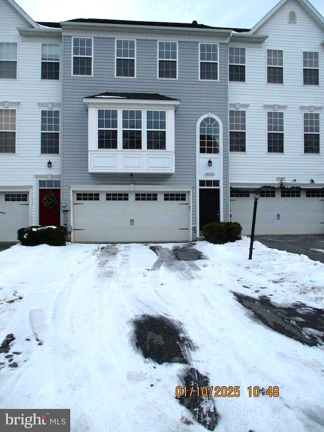 townhome / multi-family property featuring a garage