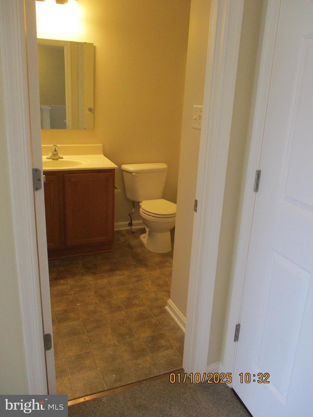 bathroom with toilet and vanity