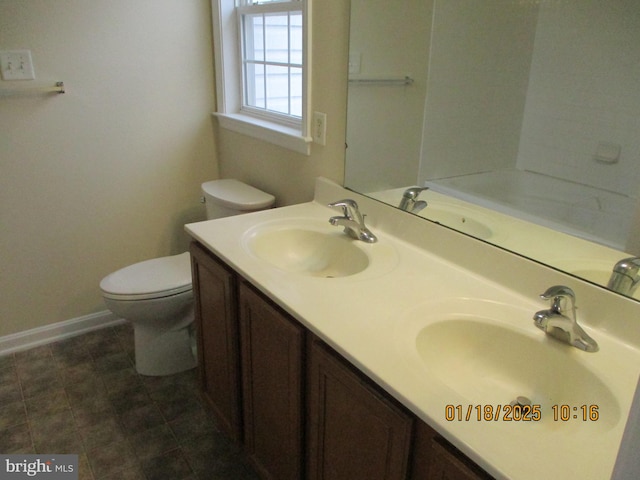 bathroom featuring toilet and vanity