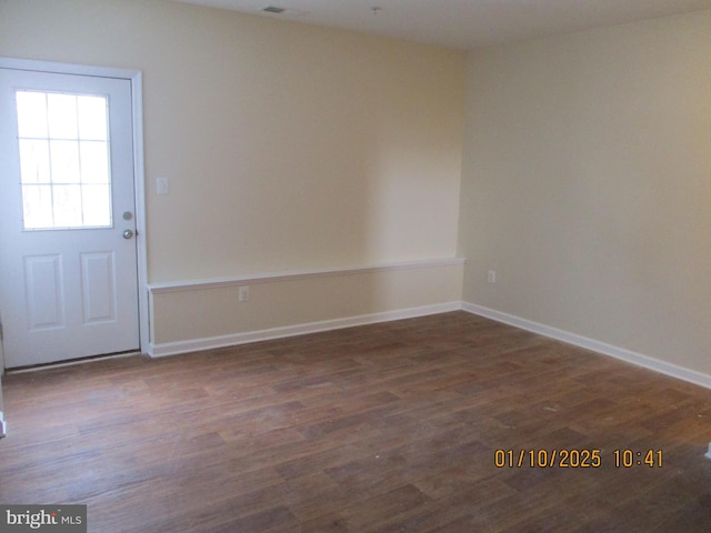 spare room with dark hardwood / wood-style flooring