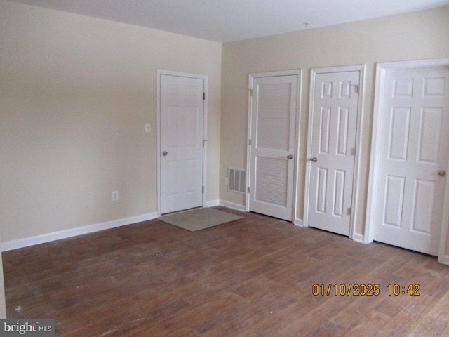 unfurnished bedroom with wood-type flooring