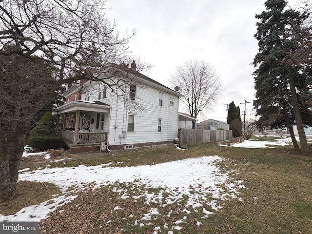 view of snowy exterior with covered porch