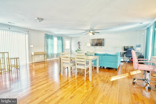 dining space with light hardwood / wood-style floors