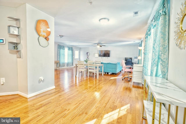 living room with ceiling fan and wood-type flooring