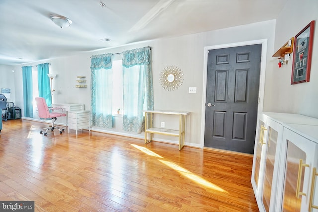 foyer entrance with washer / dryer and hardwood / wood-style floors