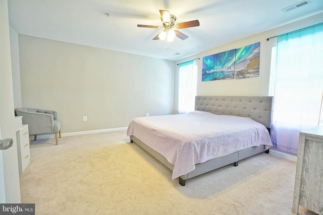 bedroom featuring ceiling fan and light carpet