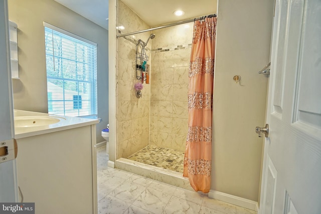 bathroom with toilet, vanity, and a shower with curtain