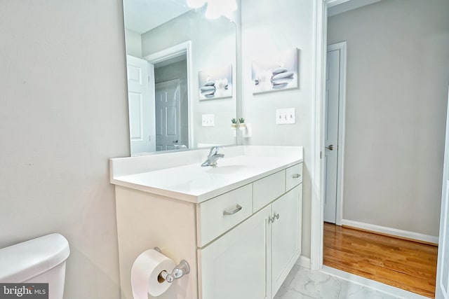 bathroom with toilet and vanity