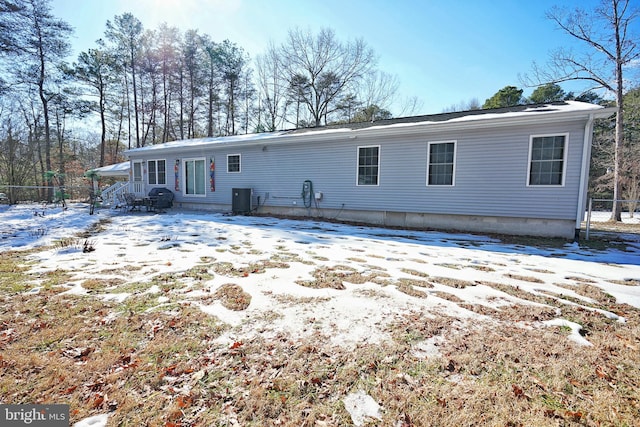 snow covered property featuring cooling unit