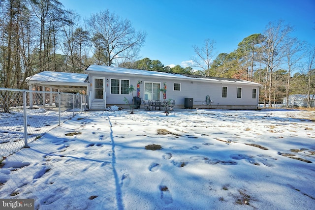 view of snow covered rear of property