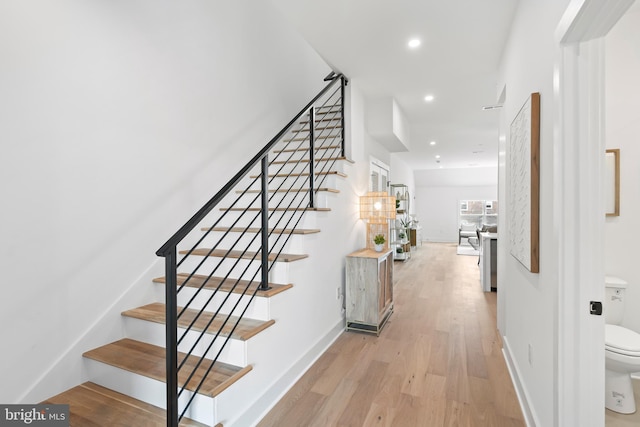 stairs featuring hardwood / wood-style flooring