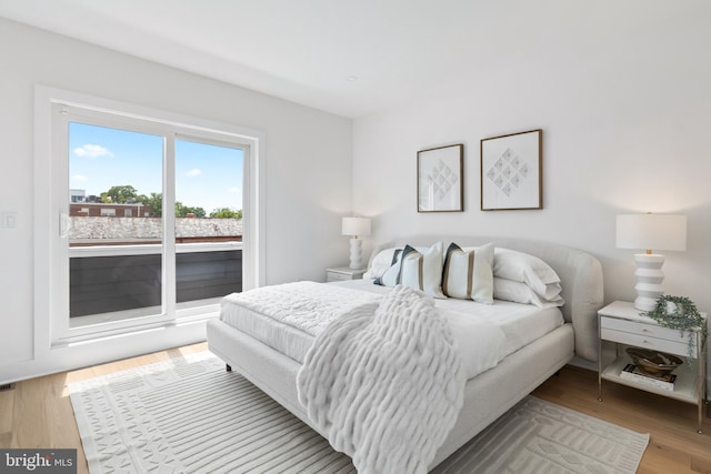 bedroom with hardwood / wood-style flooring