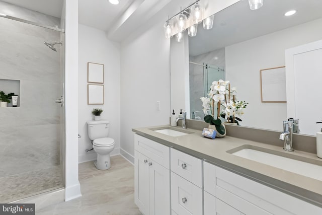 bathroom with walk in shower, vanity, and toilet