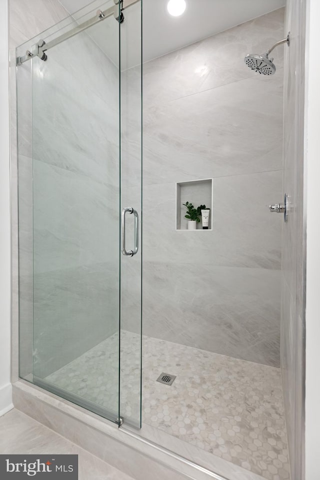 bathroom with a shower with shower door