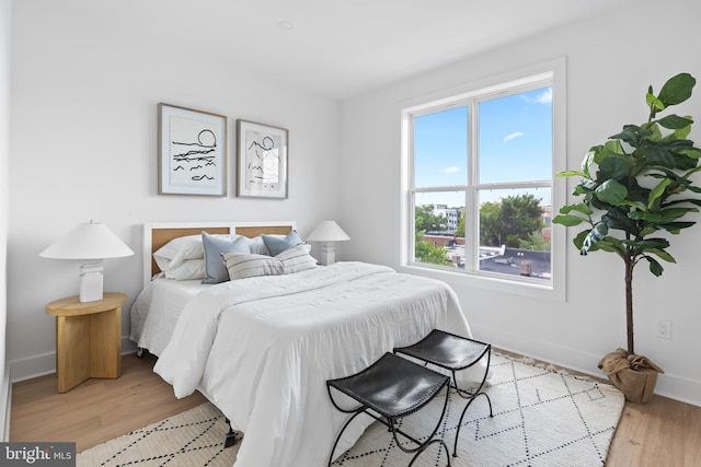 bedroom featuring light wood-type flooring and multiple windows