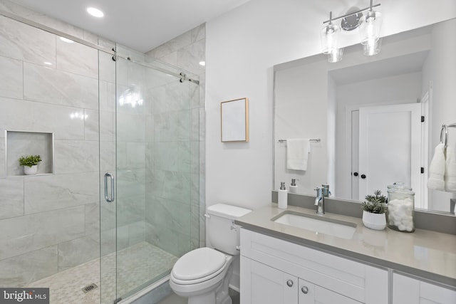 bathroom with toilet, an enclosed shower, and vanity