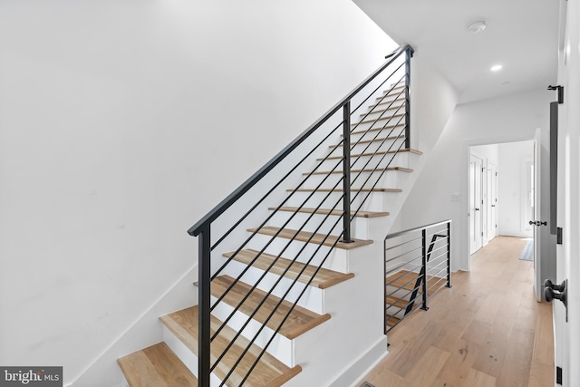 stairway featuring wood-type flooring