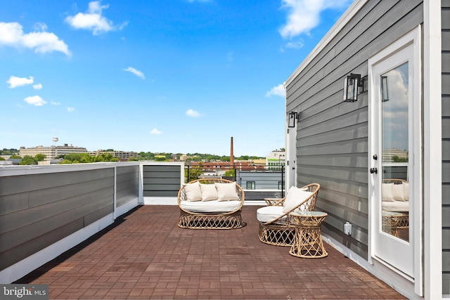 view of patio with a water view and a balcony