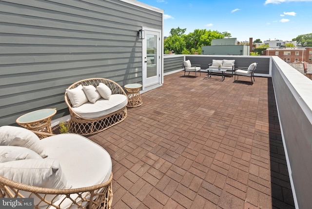 view of patio with outdoor lounge area and a balcony