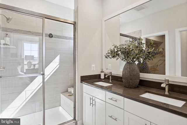 bathroom with vanity and a shower with door