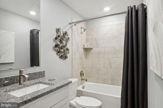 full bathroom featuring toilet, shower / bathtub combination with curtain, and vanity