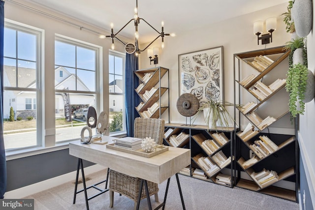 carpeted office space with a notable chandelier