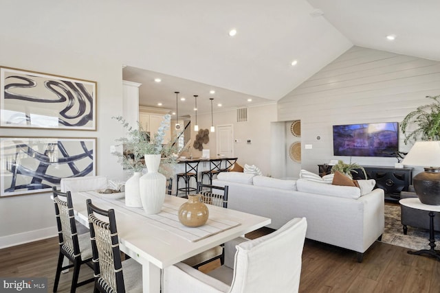 dining space with high vaulted ceiling and dark hardwood / wood-style floors