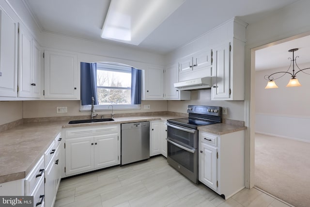 kitchen featuring sink, white cabinetry, decorative light fixtures, light colored carpet, and stainless steel appliances