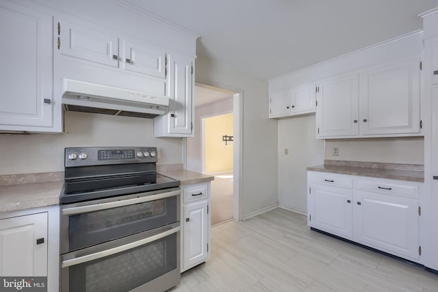 kitchen featuring range with two ovens and white cabinetry