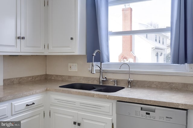 kitchen featuring white cabinetry, sink, and dishwasher