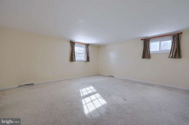 carpeted empty room with a wealth of natural light