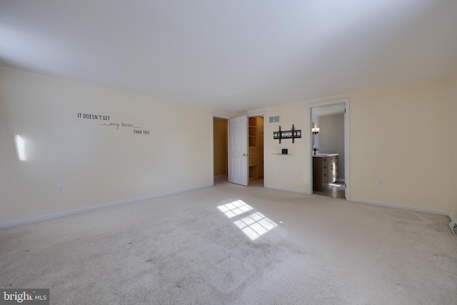 unfurnished room featuring light colored carpet