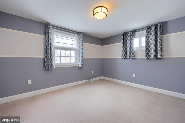 carpeted empty room with a healthy amount of sunlight