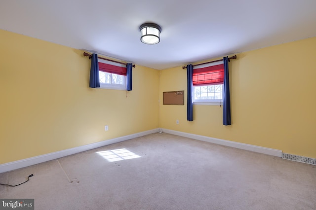 unfurnished room with carpet and a wealth of natural light