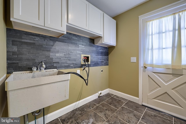 washroom with electric dryer hookup, hookup for a washing machine, and cabinets