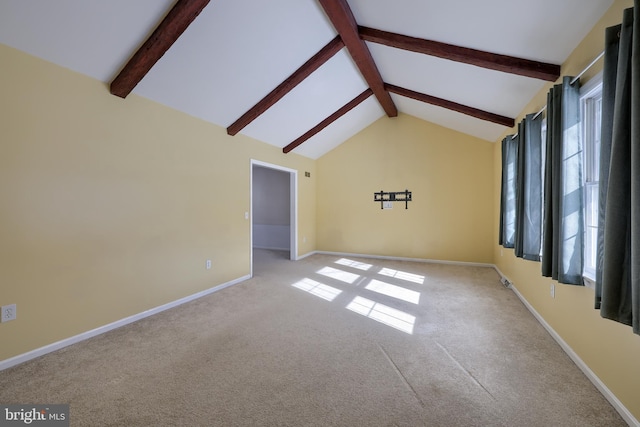 carpeted empty room featuring lofted ceiling with beams