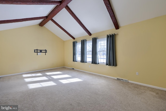 carpeted spare room featuring vaulted ceiling with beams