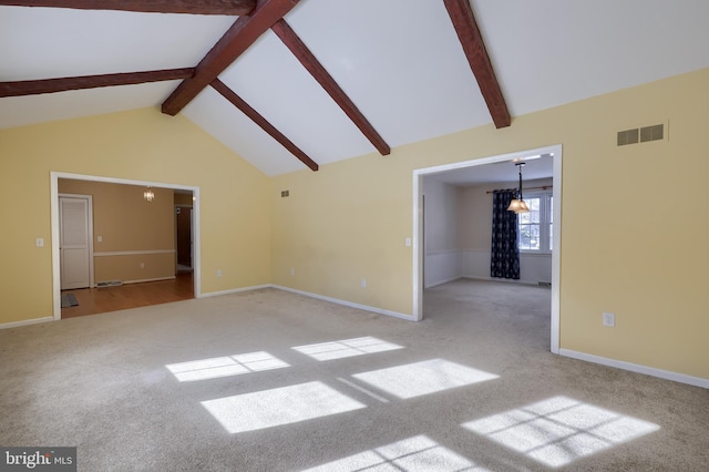 unfurnished living room with beamed ceiling, light colored carpet, and high vaulted ceiling