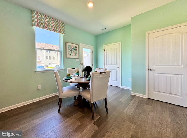 dining space with dark wood-type flooring