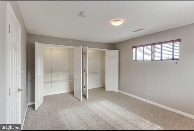 unfurnished bedroom featuring light carpet