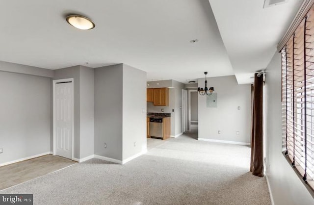 unfurnished living room with light carpet and a chandelier