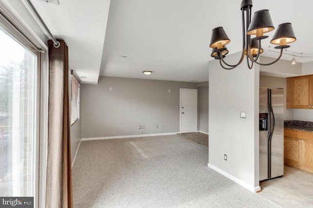 interior space featuring light colored carpet and an inviting chandelier