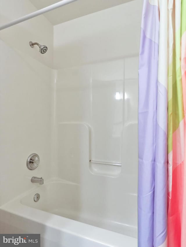 bathroom with shower / bathtub combination with curtain