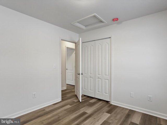 unfurnished bedroom featuring hardwood / wood-style floors and a closet