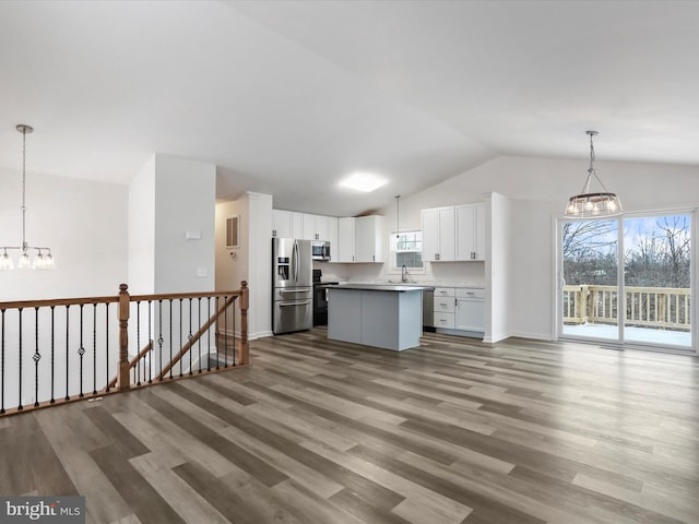 kitchen with pendant lighting, white cabinets, a chandelier, a center island, and stainless steel appliances